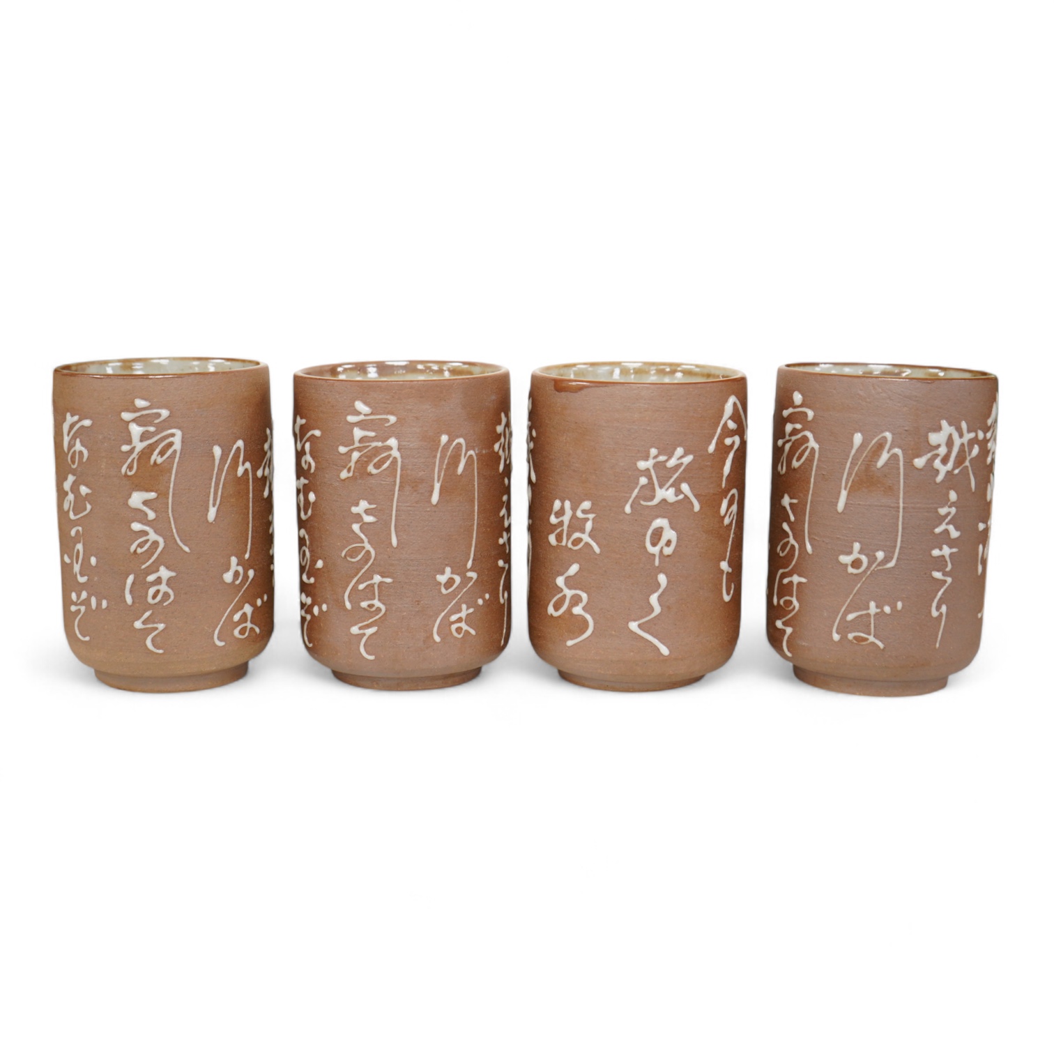A set of four Japanese studio pottery beakers with calligraphy, 11cm high